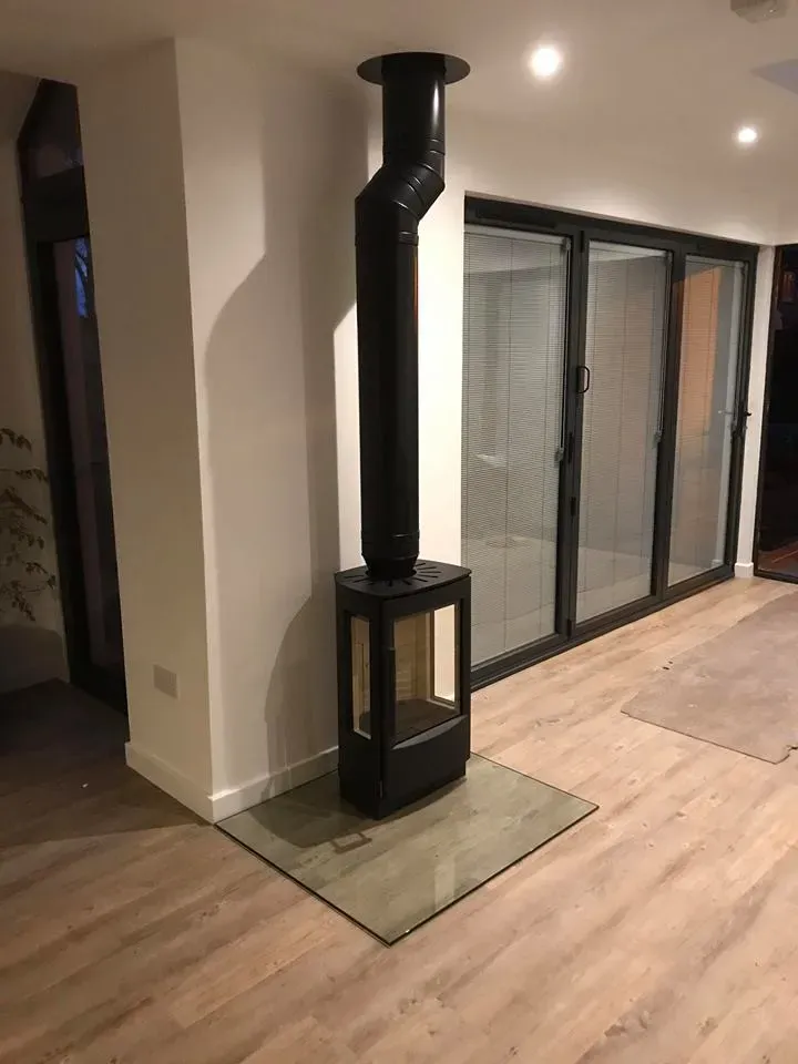 Contemporary three sided stove in an open plan room by Agnew Chimney Engineering Glasgow