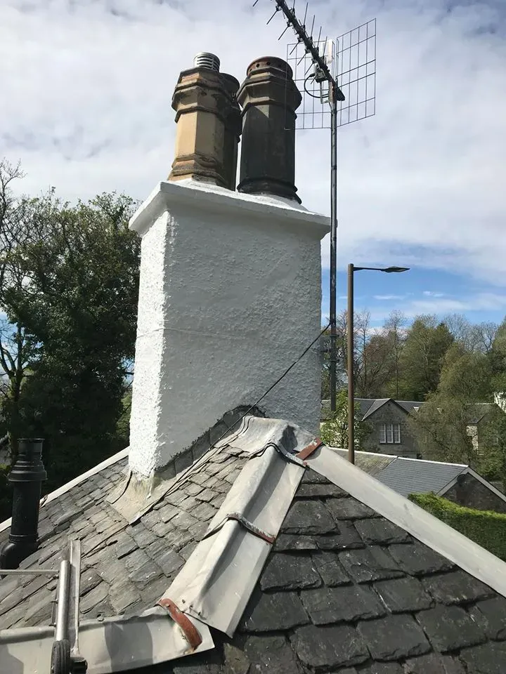 Refurbished white chimney stack on a slate roof by Agnew Chimney Engineering Glasgow