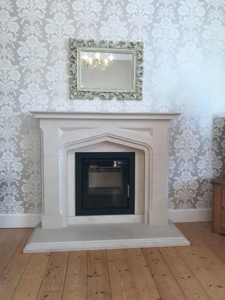 Stove in a white stone fireplace by Agnew Chimney Engineering Glasgow