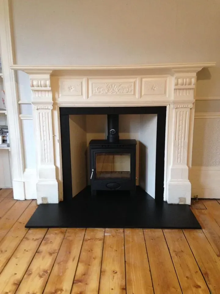 Stove inside a white period mantelpiece by Agnew Chimney Engineering Glasgow