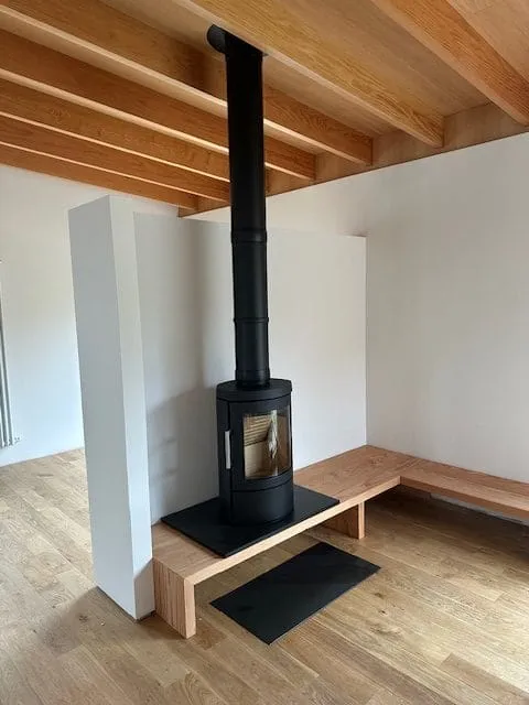 Freestanding stove with flue on a raised hearth by Agnew Chimney Engineering Glasgow