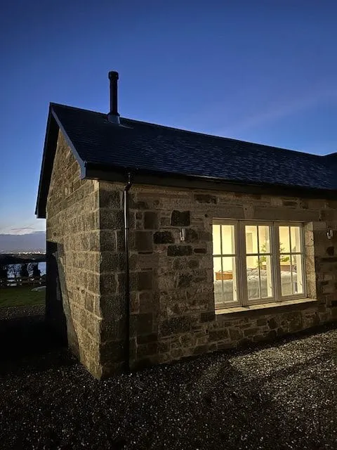 Stone cottage with chimney at dusk by Agnew Chimney Engineering Glasgow